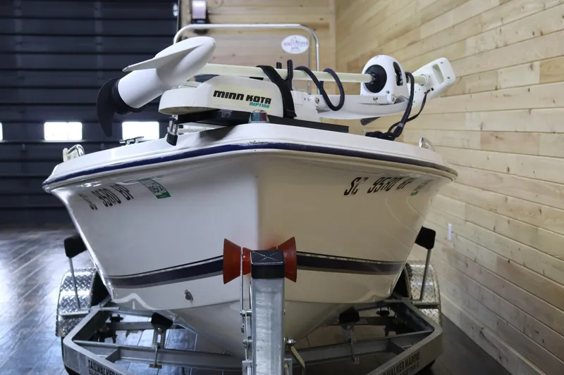 Slide: The Image of 2002 Cobia 174 Center Console boat on trailer in indoor storage. - 8