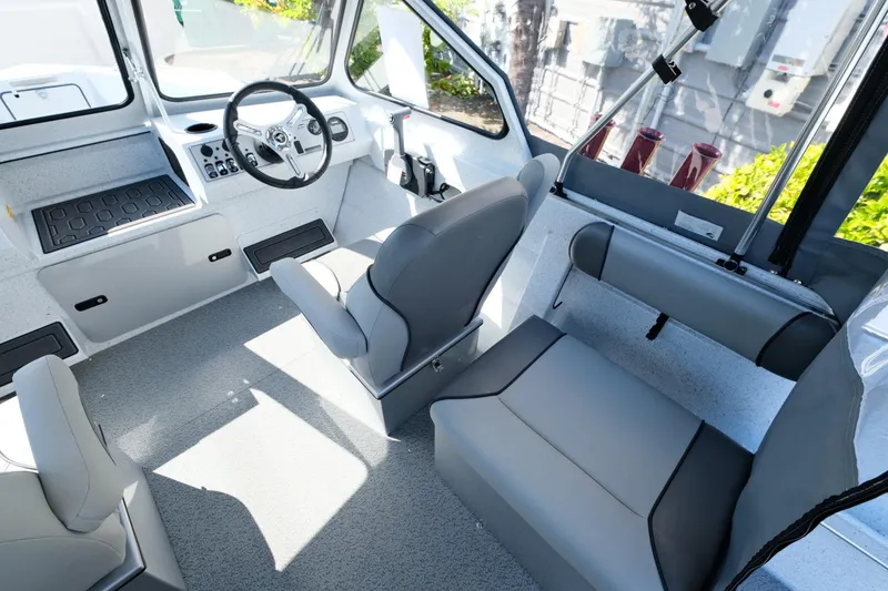 Slide: The Image of 2024 KingFisher 1825 Falcon boat interior with modern seating and steering console. - 11
