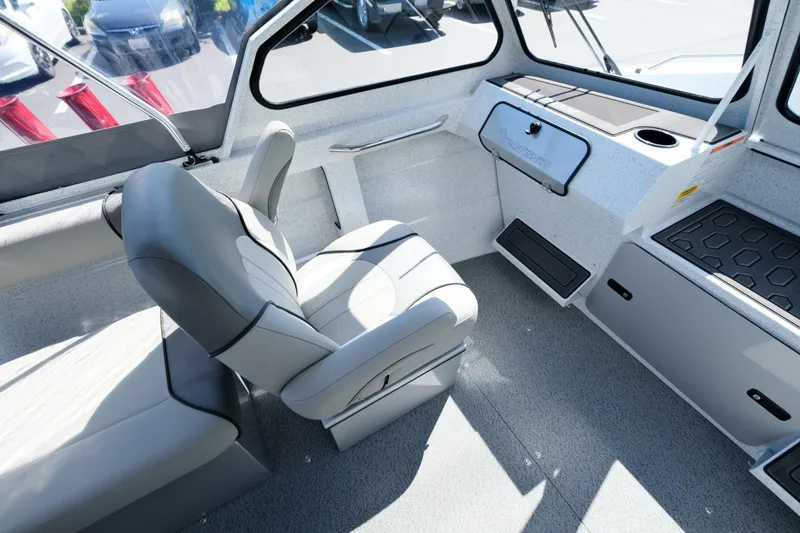 Slide: The Image of Interior of 2024 KingFisher 1825 Falcon boat, featuring modern seating and dashboard. - 15