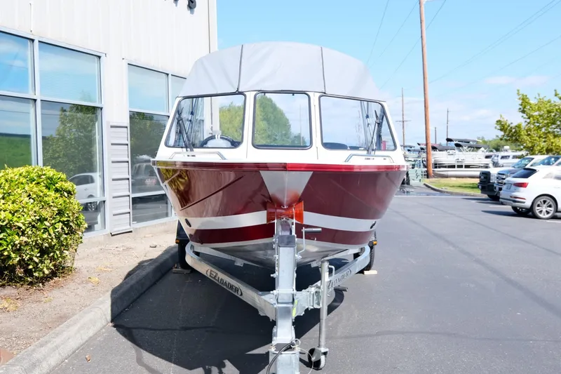 Slide: The Image of 2024 KingFisher 1825 Falcon boat on trailer, parked outside a building. - 3