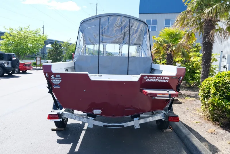 Slide: The Image of 2024 KingFisher 1825 Falcon boat on trailer, parked near palm trees. - 4