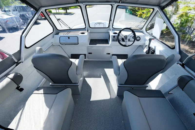Slide: The Image of Interior of 2024 KingFisher 1825 Falcon boat, featuring modern seating and steering console. - 8