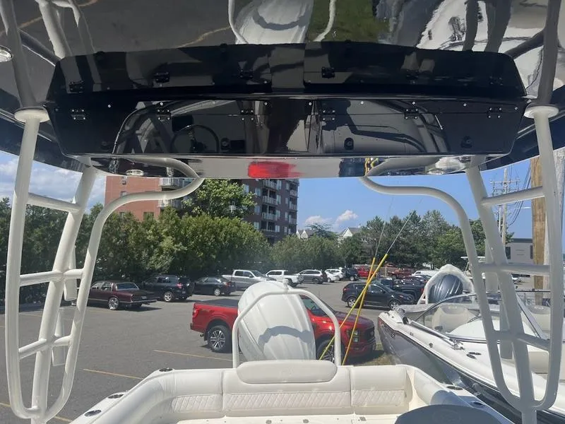 Slide: The Image of 2025 Key West 239 DFS boat interior with seating and overhead view in a parking lot. - 13