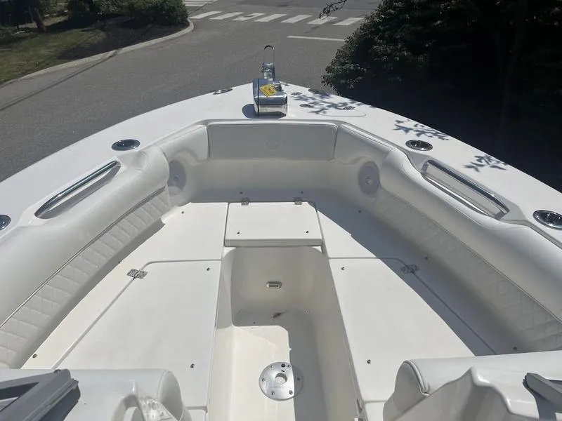 Slide: The Image of 2025 Key West 239 DFS boat interior with white seating and storage compartments. - 14