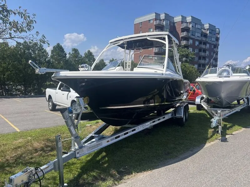 Slide: The Image of 2025 Key West 239 DFS boat on trailer, parked outdoors near buildings. - 5