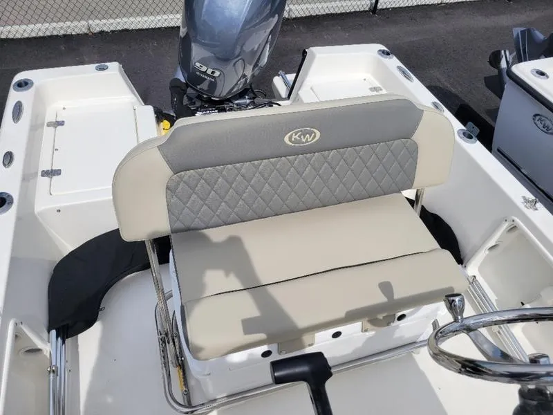 Slide: The Image of 2025 Key West 1720 CC boat interior with cushioned seating and steering wheel. - 10