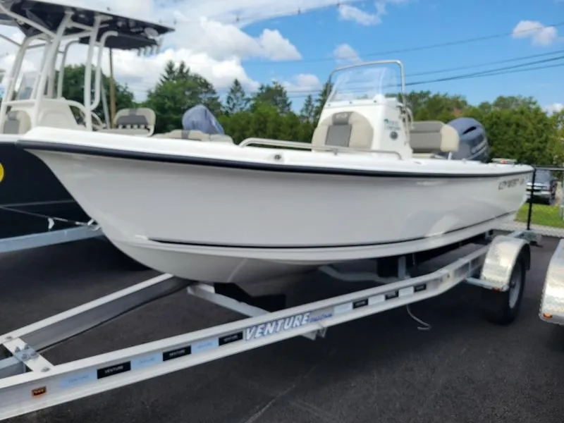 Slide: The Image of 2025 Key West 1720 CC boat on trailer, parked outdoors under blue sky. - 5