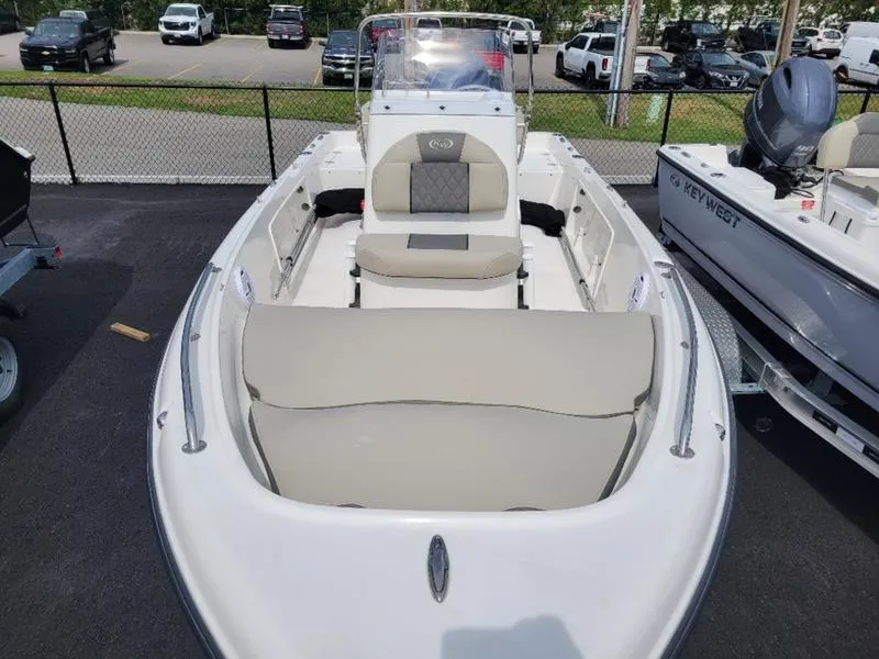 Slide: The Image of 2025 Key West 1720 CC boat with spacious seating, parked outdoors. - 7