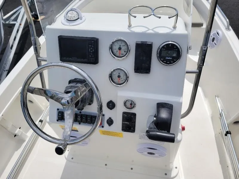 Slide: The Image of 2025 Key West 1720 CC boat dashboard with steering wheel and gauges. - 9