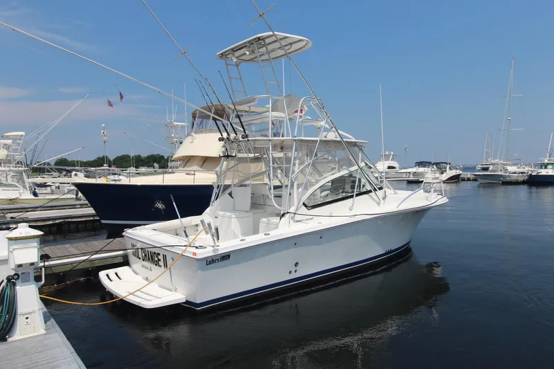 Slide: The Image of 2007 Luhrs 28 Open boat docked at marina, clear sky, calm water. - 1
