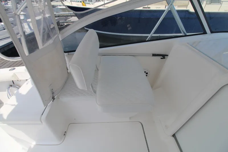 Slide: The Image of 2007 Luhrs 28 Open boat interior with white seating and clear enclosure. - 12