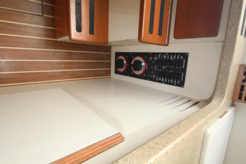 Slide: The Image of 2007 Luhrs 28 Open interior with control panel and wooden cabinetry. - 17