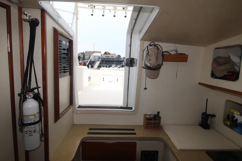 Slide: The Image of Interior view of 2007 Luhrs 28 Open boat, featuring a hatch and storage area. - 19