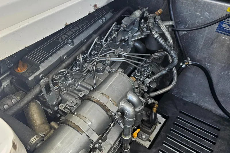 Slide: The Image of Engine compartment of a 2007 Luhrs 28 Open boat, featuring a Yanmar engine. - 25