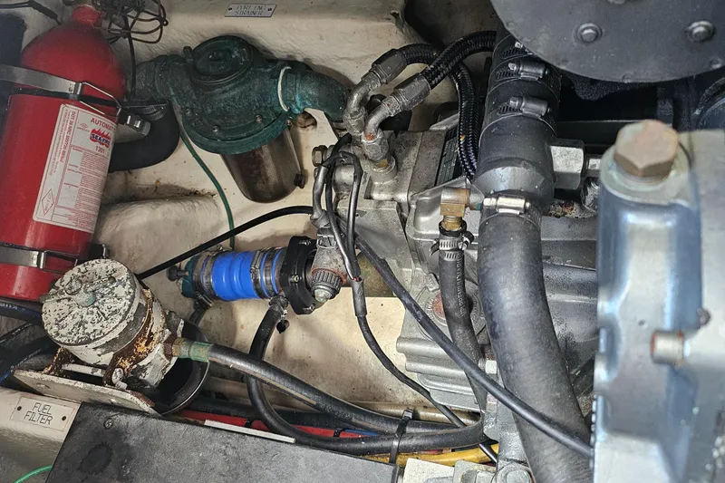 Slide: The Image of Engine compartment of a 2007 Luhrs 28 Open boat, featuring hoses and a fire extinguisher. - 26