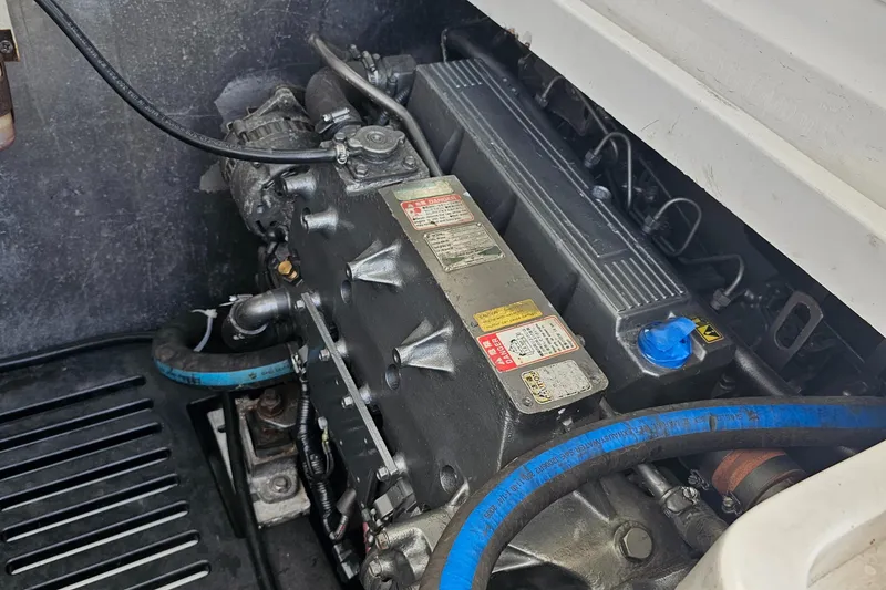 Slide: The Image of Engine compartment of a 2007 Luhrs 28 Open boat, featuring visible components and blue hoses. - 27