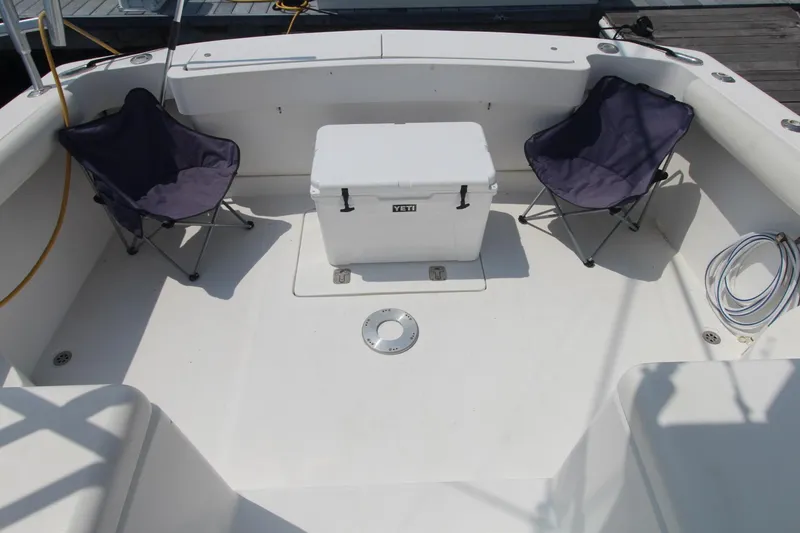 Slide: The Image of 2007 Luhrs 28 Open boat deck with chairs and cooler. - 5