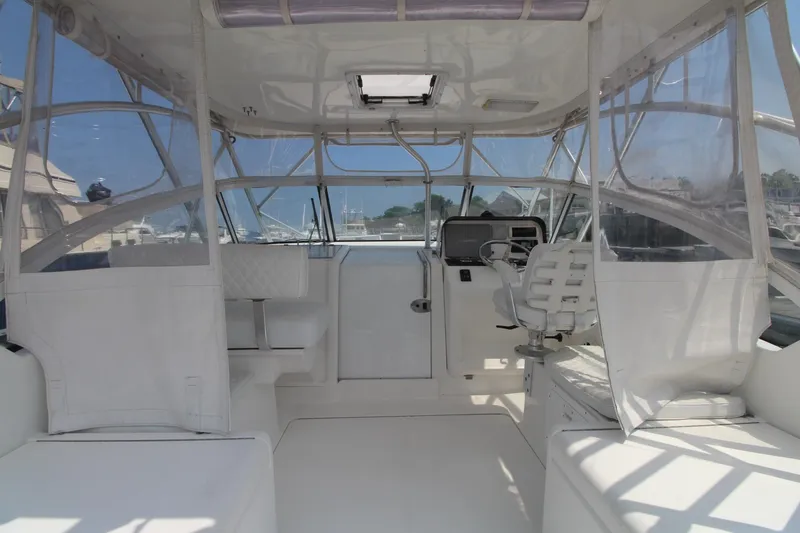 Slide: The Image of 2007 Luhrs 28 Open boat interior with helm, seating, and clear enclosures. - 7