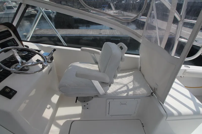 Slide: The Image of 2007 Luhrs 28 Open boat cockpit with steering wheel and white captain's chair. - 9