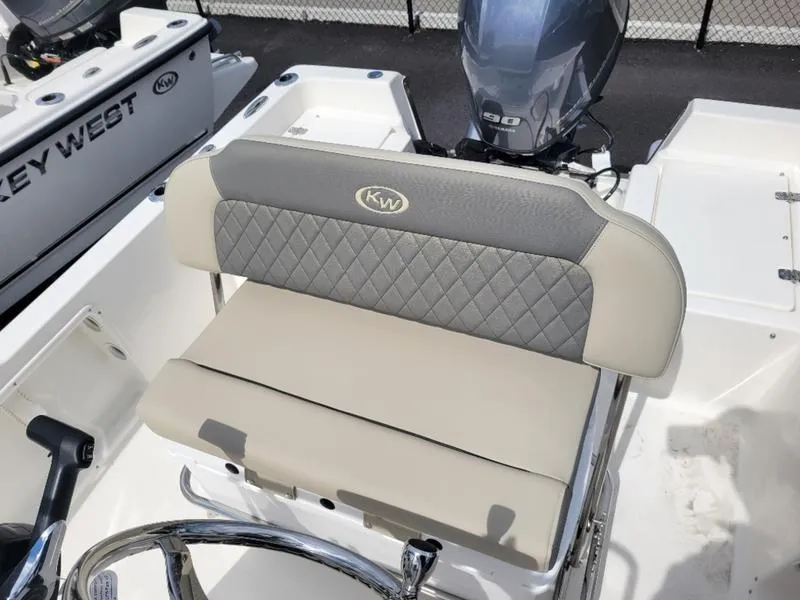 Slide: The Image of 2025 Key West 1720 CC boat seat with KW logo and steering wheel. - 11