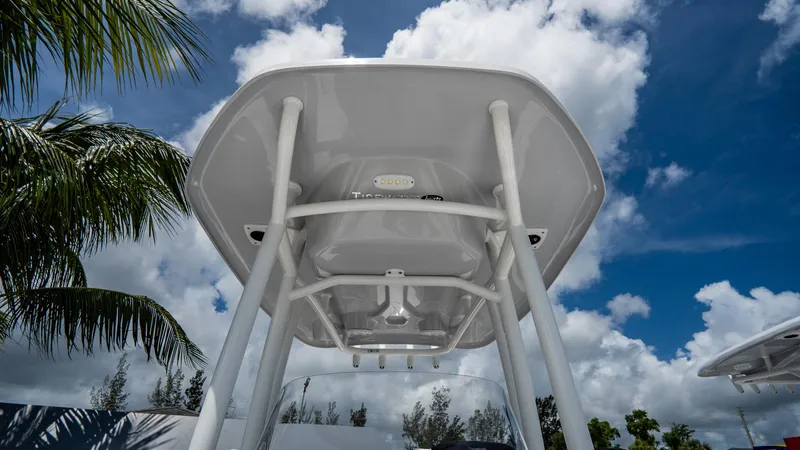 Slide: The Image of 2025 Tidewater 2300 Carolina Bay boat T-top under a blue sky. - 13