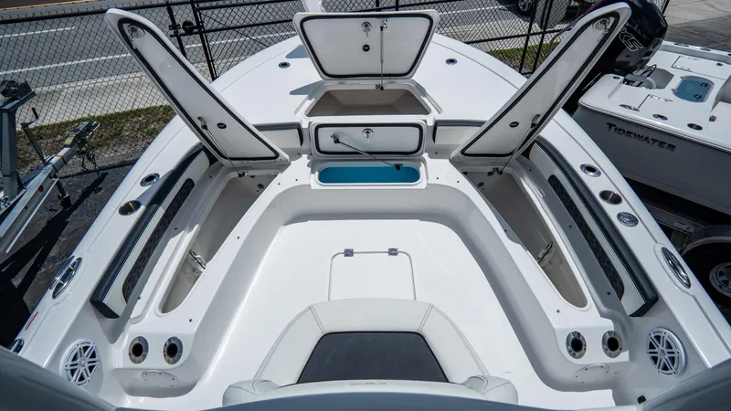Slide: The Image of 2025 Tidewater 2300 Carolina Bay boat with open storage compartments. - 16