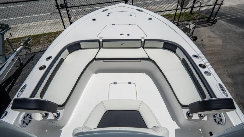 Slide: The Image of 2025 Tidewater 2300 Carolina Bay boat interior with cushioned seating and storage compartments. - 17