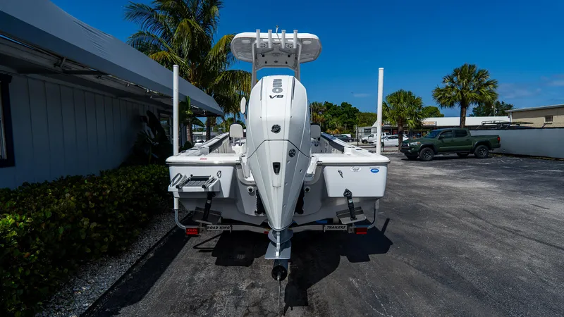 Slide: The Image of 2025 Tidewater 2300 Carolina Bay boat, rear view, parked outdoors on a sunny day. - 2