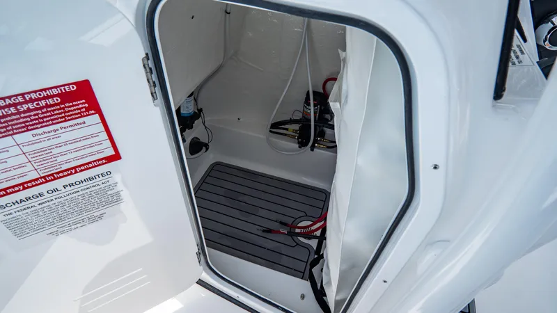 Slide: The Image of 2025 Tidewater 2300 Carolina Bay storage compartment with safety instructions. - 22