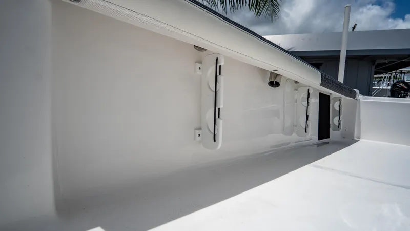 Slide: The Image of 2025 Tidewater 2300 Carolina Bay boat interior detail with rod holders. - 23