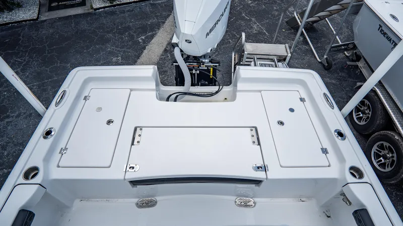 Slide: The Image of 2025 Tidewater 2300 Carolina Bay boat stern with outboard motor and storage compartments. - 6