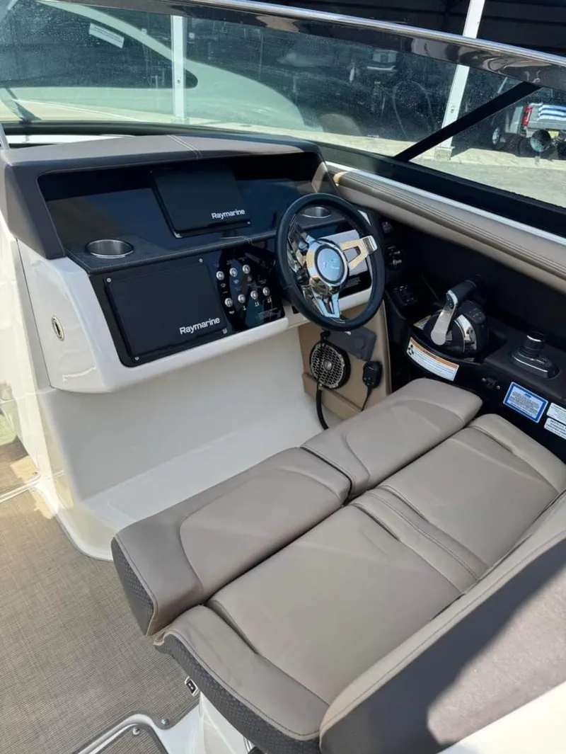 Slide: The Image of 2018 Sea Ray SLX 350 OB boat cockpit with steering wheel and control panel. - 13
