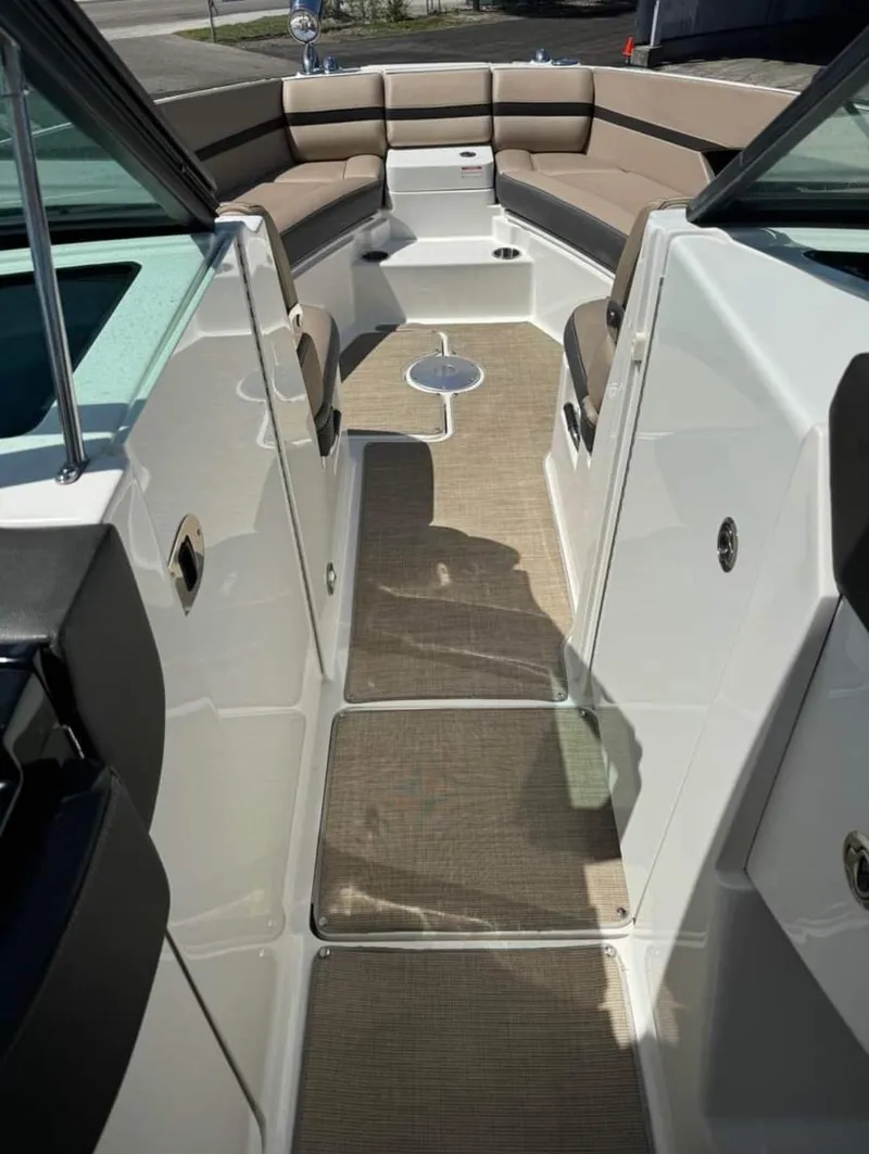 Slide: The Image of 2018 Sea Ray SLX 350 OB boat interior with beige seating and carpeted floor. - 16