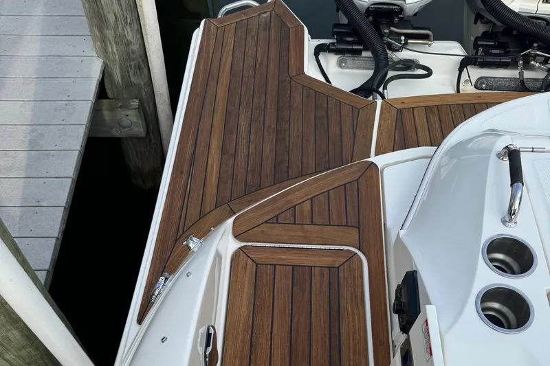 Slide: The Image of 2018 Sea Ray SLX 350 OB boat deck with wood finish and sleek design. - 20