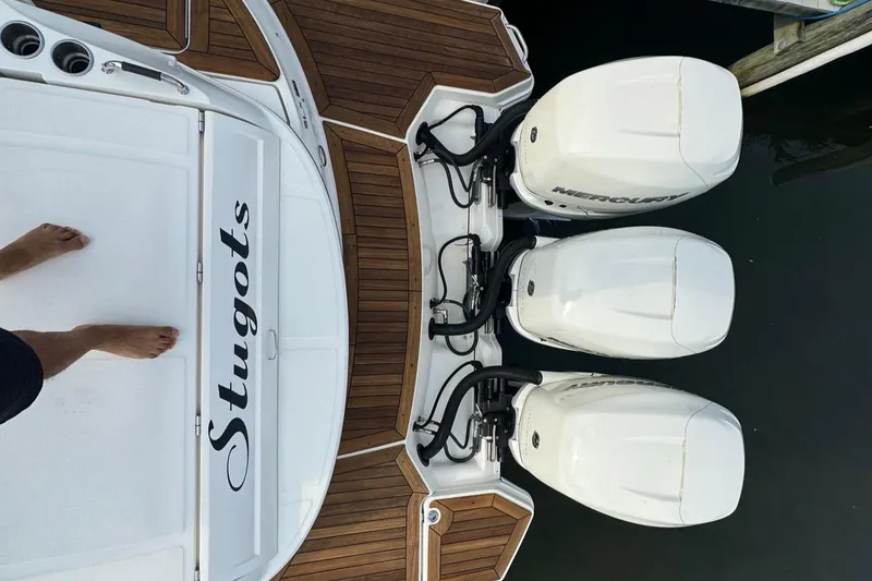 Slide: The Image of 2018 Sea Ray SLX 350 OB with triple outboard engines, wooden deck, and custom nameplate. - 22