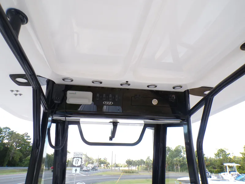 Slide: The Image of 2025 Sea Hunt Ultra 305 SE boat console with electronic controls and storage. - 12