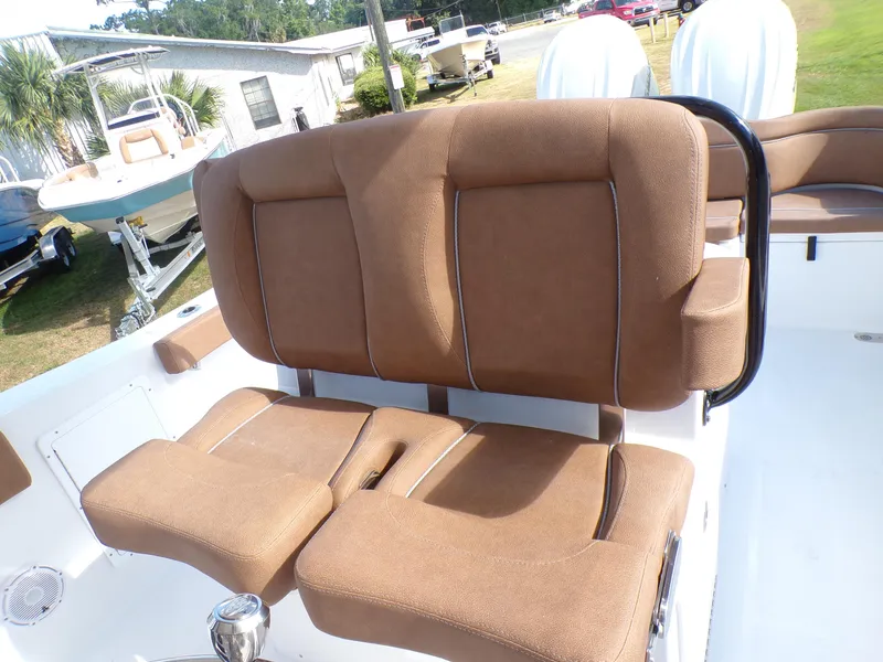 Slide: The Image of 2025 Sea Hunt Ultra 305 SE boat with brown cushioned seating. - 13