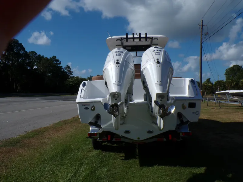 Slide: The Image of 2025 Sea Hunt Ultra 305 SE boat with twin outboard engines, rear view. - 2
