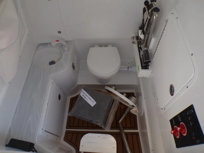 Slide: The Image of 2025 Sea Hunt Ultra 305 SE boat interior with toilet and sink - 22