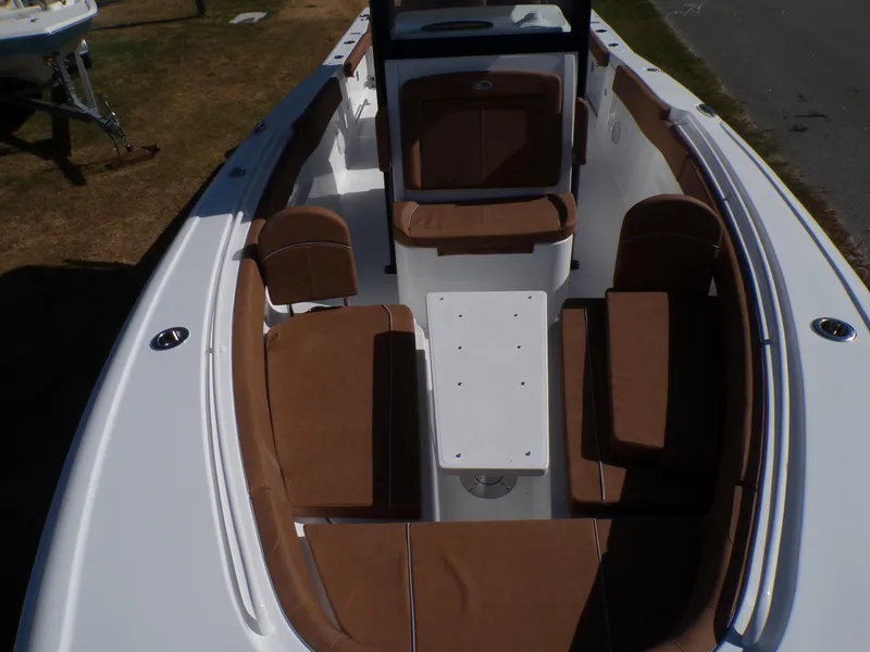 Slide: The Image of 2025 Sea Hunt Ultra 305 SE boat interior with brown seating and white table. - 4