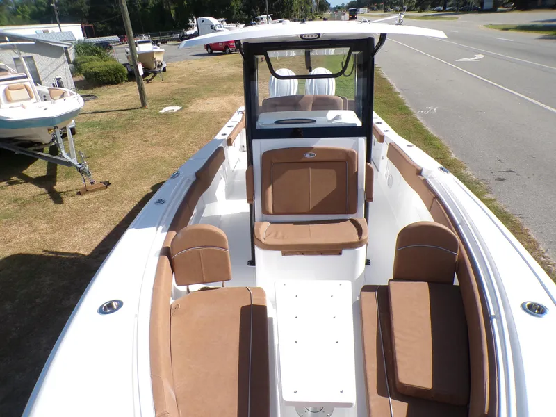 Slide: The Image of 2025 Sea Hunt Ultra 305 SE boat with tan seating and white deck. - 7