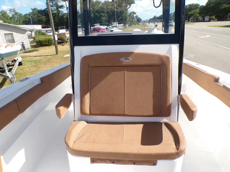 Slide: The Image of 2025 Sea Hunt Ultra 305 SE boat with brown cushioned seating. - 9