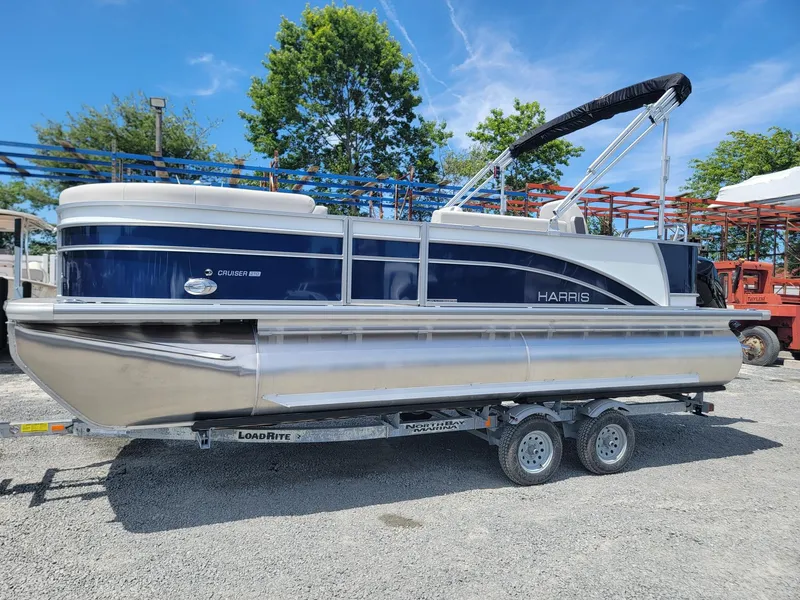 Slide: The Image of 2025 Harris Cruiser 210 pontoon boat on a trailer, ready for transport. - 1