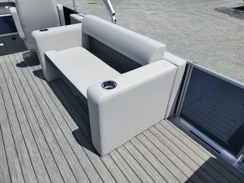 Slide: The Image of 2025 Harris Cruiser 210 boat with comfortable seating and cup holders on deck. - 11