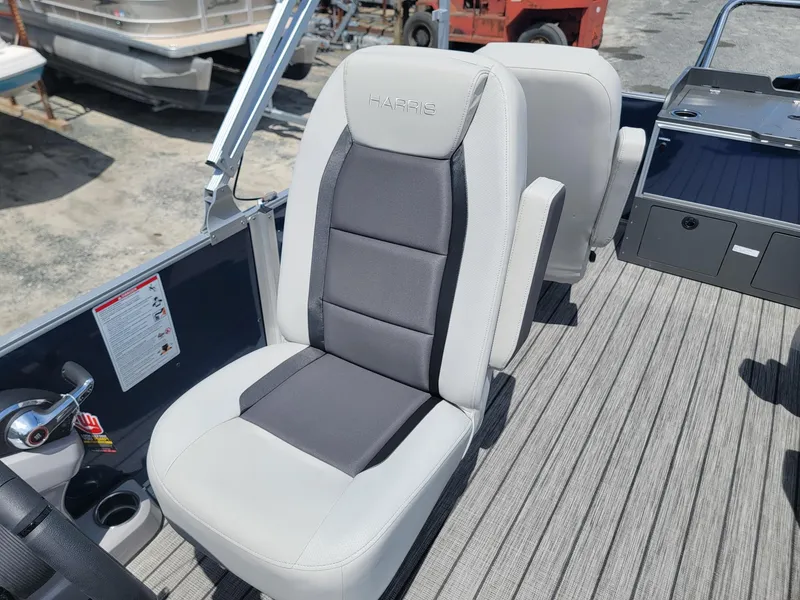 Slide: The Image of 2025 Harris Cruiser 210 boat seat with gray and white upholstery. - 12