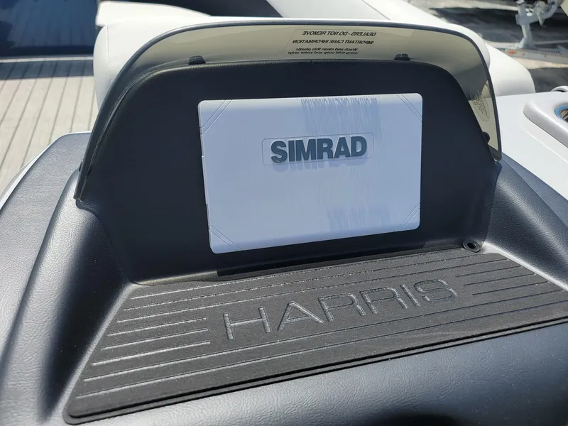 Slide: The Image of 2025 Harris Cruiser 210 boat dashboard with Simrad display. - 14