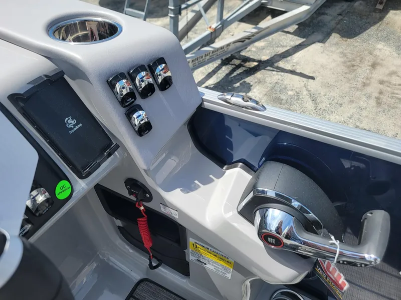 Slide: The Image of Control panel of 2025 Harris Cruiser 210 boat with throttle and switches. - 18