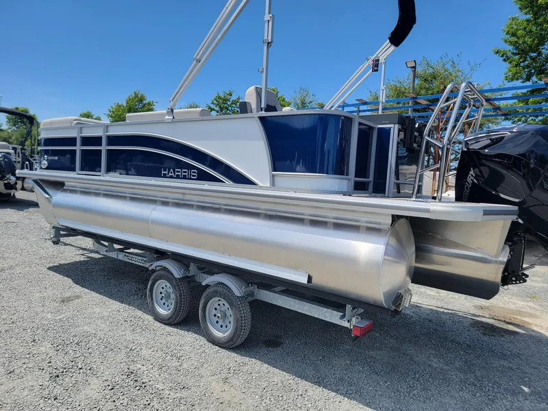 Slide: The Image of 2025 Harris Cruiser 210 pontoon boat on a trailer. - 2