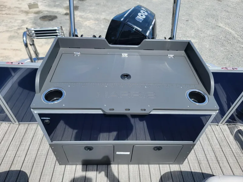Slide: The Image of 2025 Harris Cruiser 210 boat with storage compartments and cup holders. - 23