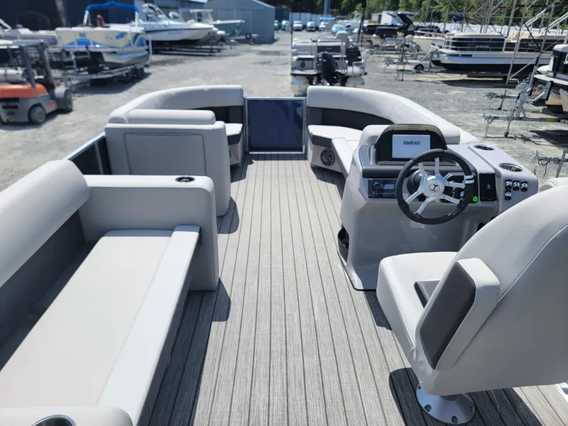 Slide: The Image of 2025 Harris Cruiser 210 pontoon boat interior with modern seating and steering console. - 28